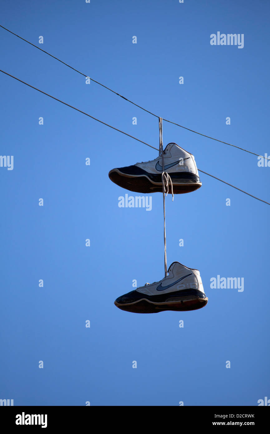 Tennis shoes over the wires is an urban statement Stock Photo Alamy
