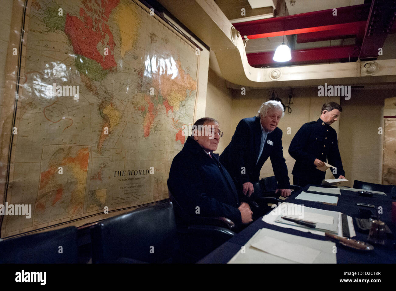 US Secretary of Defense Leon Panetta sits at Winston Churchill's seat as Phil Reed gives him a tour of the briefing room at Churchill's War Rooms January 19, 2013 in London, England, UK. Panetta is on a six day trip to Europe to meet with leaders and US troops. Stock Photo