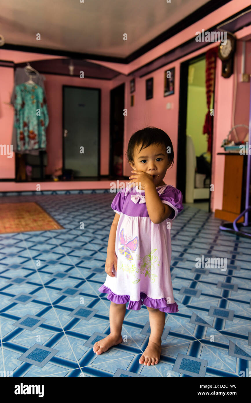 Child in a traditional house on water at fisherman village on Gaya island Sabah Borneo Malaysia Stock Photo