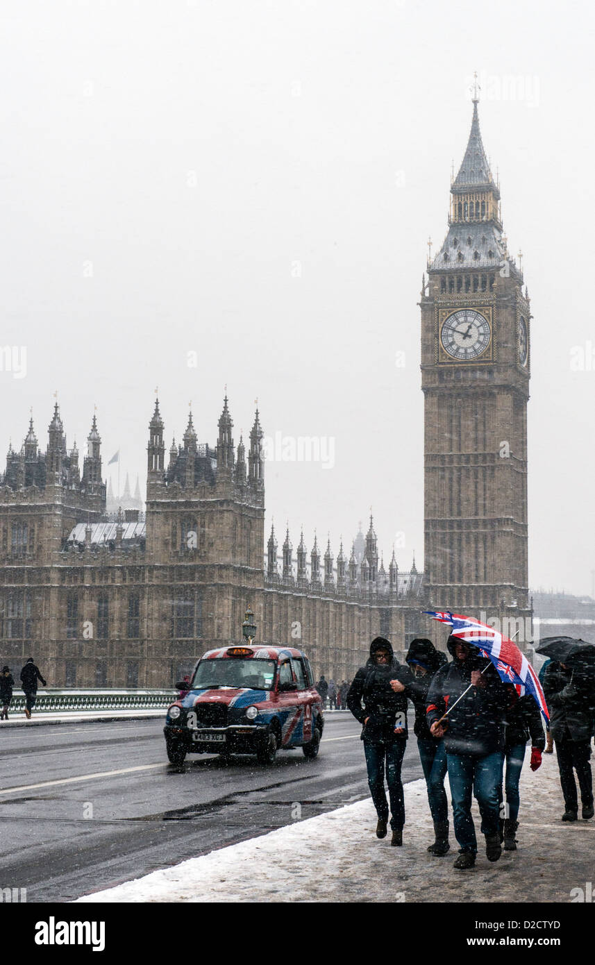 Black cab and people walking with union jack umbrella over Westminster bridge London England Great Britain UK Stock Photo