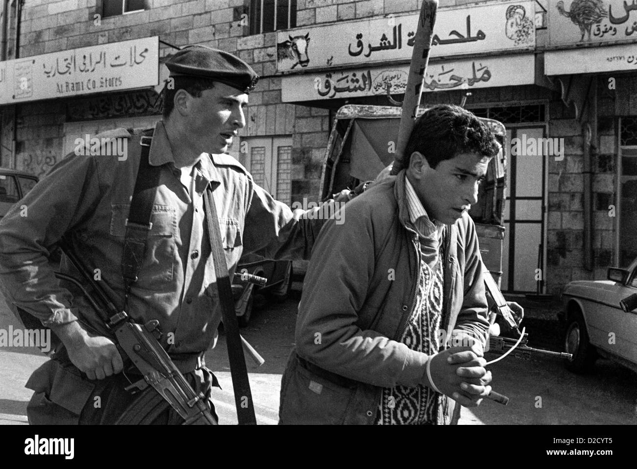 1988 Ramallah. Palestinian arrested for allegedly throwing stones at the beginning of the Palestinian Intifada. Stock Photo