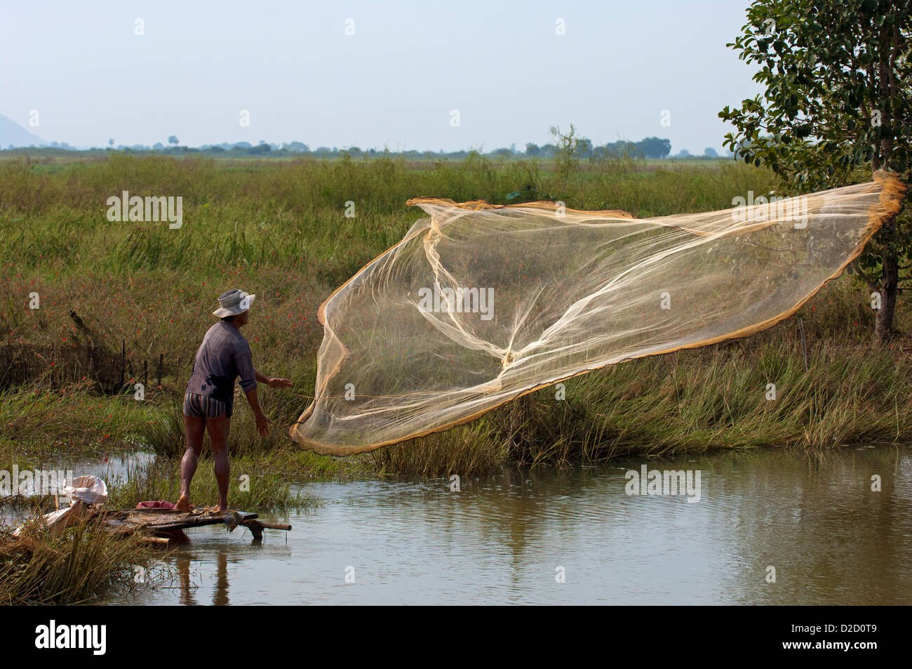 Fisherman throwing a cast net in a river, Battambang, Cambodia Stock Photo  - Alamy