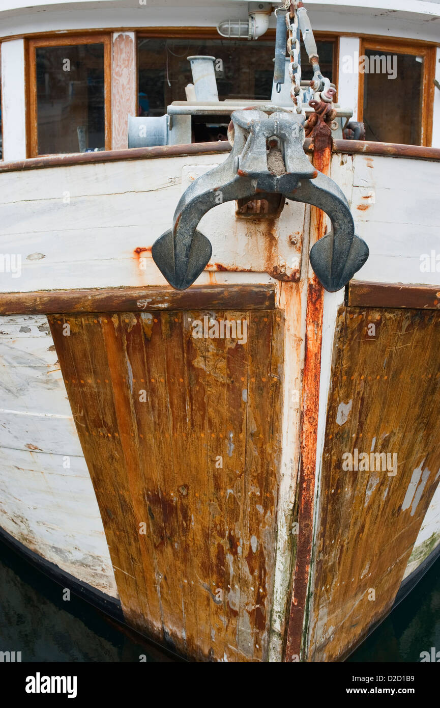 Close up view of old wooded fishing boat bow and anchor in Sitka, Alaska, USA Stock Photo