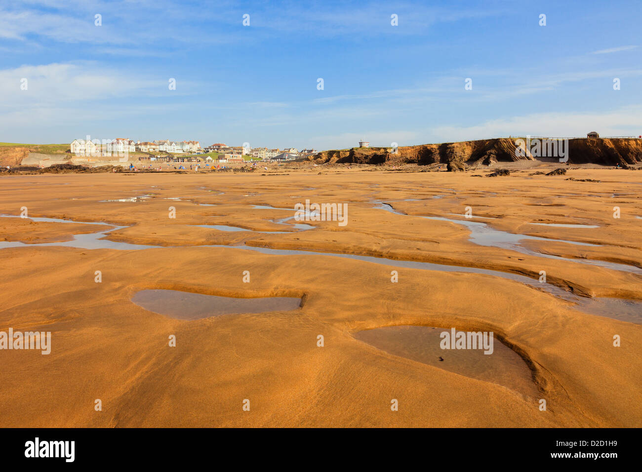 View to seafront from across Crooklets sandy beach with tidal pools at low tide in summer in Bude, Cornwall, England, UK, Stock Photo