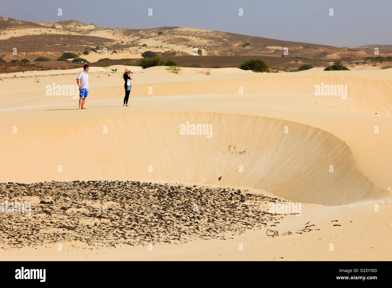 Two tourists photographing the desert sand at Deserto de Viana, Boa Vista, Cape Verde Islands, Africa. Stock Photo