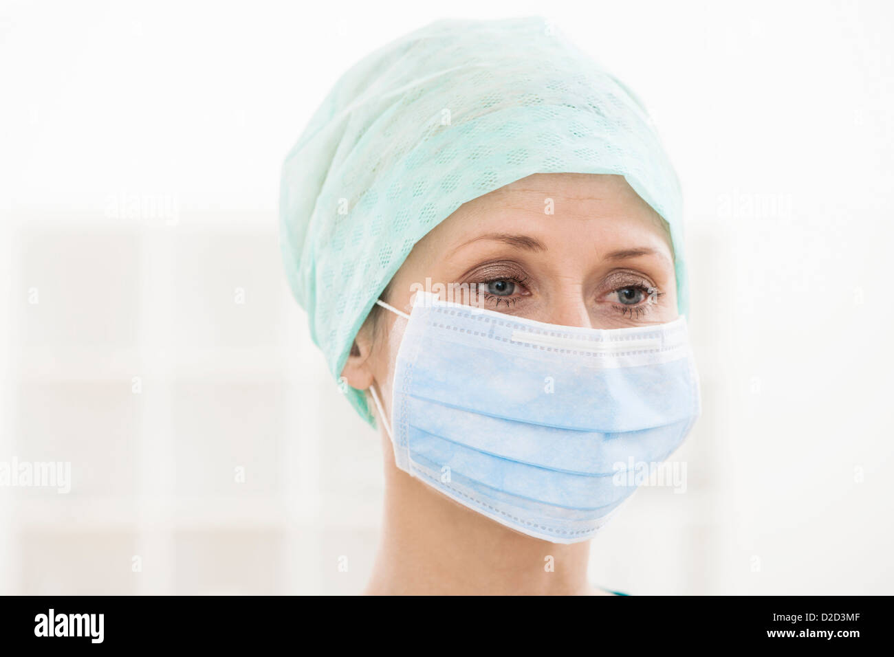 MODEL RELEASED Surgeon wearing a surgical mask and cap Stock Photo - Alamy