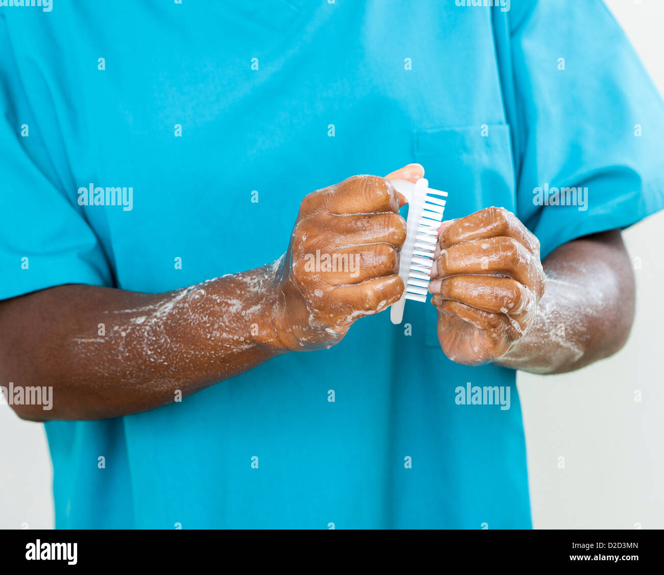 MODEL RELEASED Scrubbing up before surgery Stock Photo