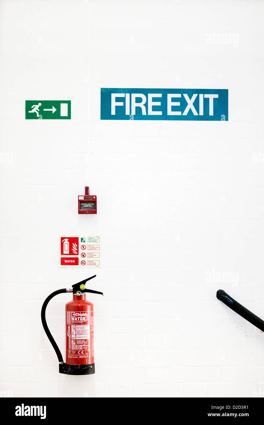 Fire safety Fire extinguisher fire alarm and fire exit signs on a wall