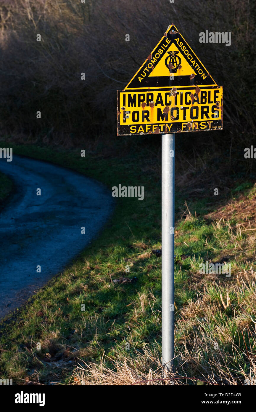 An old AA road sign warning 'impracticable for motors' on a steep and remote country lane in mid-Wales, UK Stock Photo