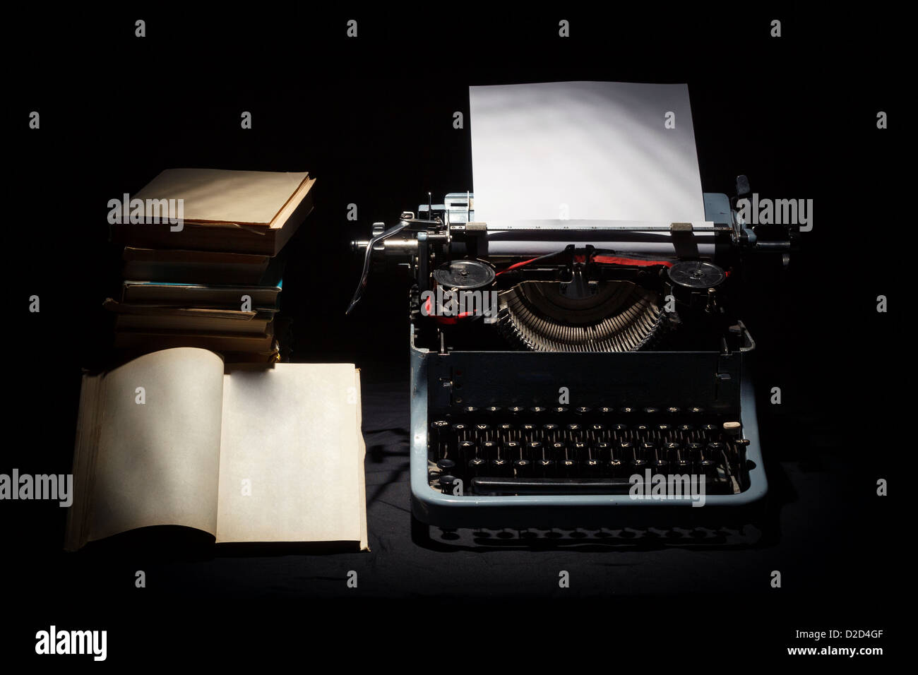 retro typewriter with stack of book and one opened book black ...