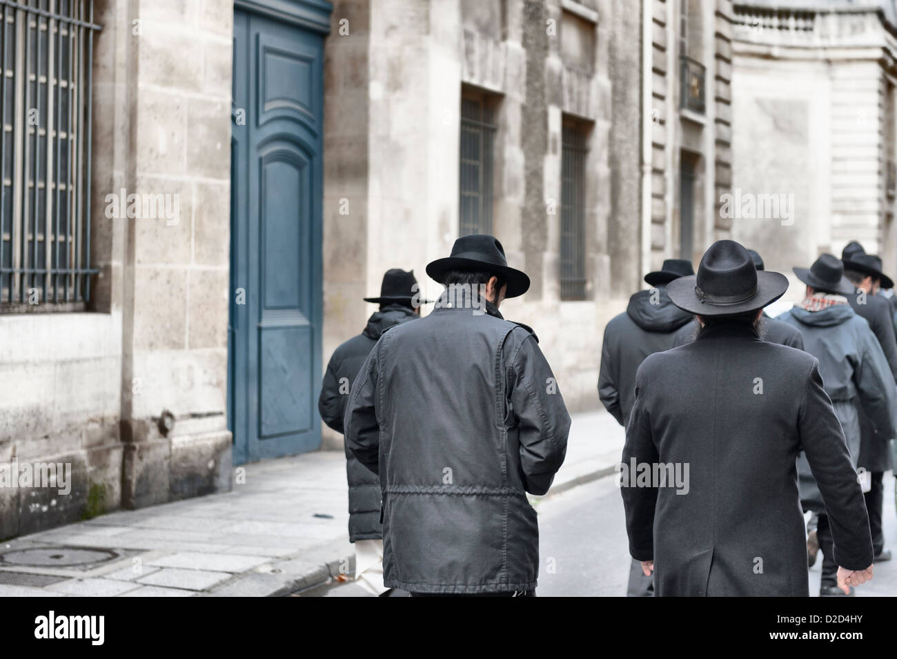Jewish men in traditional wide-brimmed hats returning as a group from Synagogue on the Sabbath in Le Marais, Paris. Stock Photo