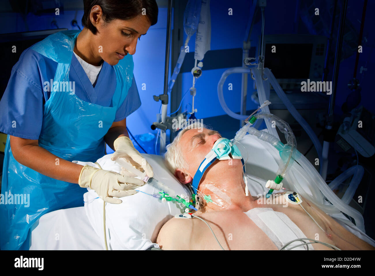 MODEL RELEASED Administering drugs through a central line Stock Photo