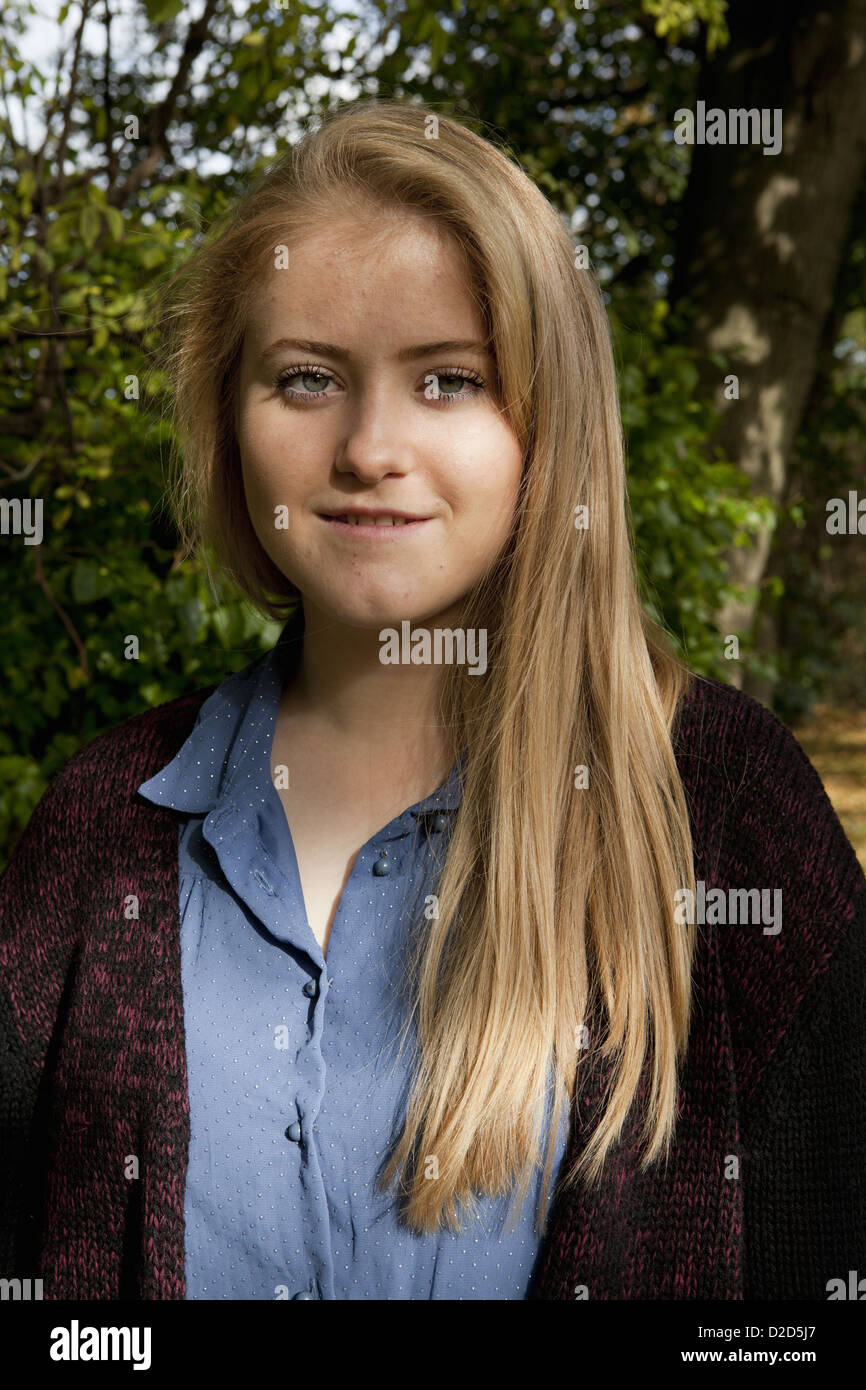 Smiling girl standing in forest Stock Photo - Alamy