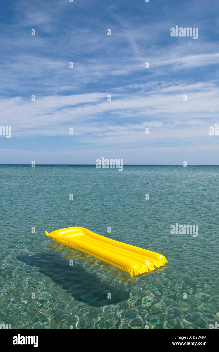 A yellow inflatable raft floating on the sea, Budoni, Sardinia, Italy