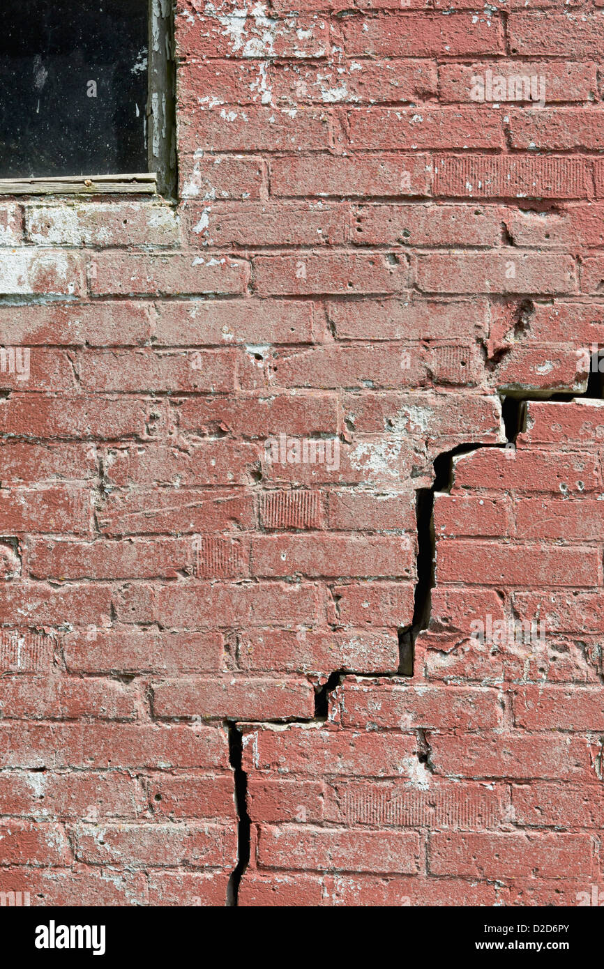 Close-up of a crack running through a red brick wall Stock Photo