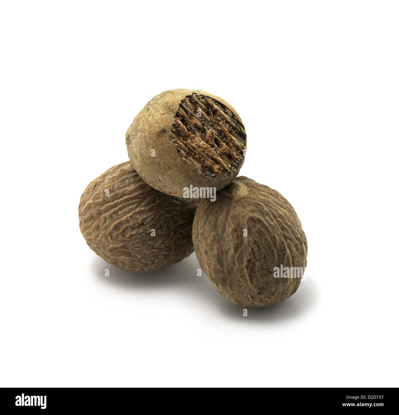 Three balls of Nutmeg cut out white background Stock Photo