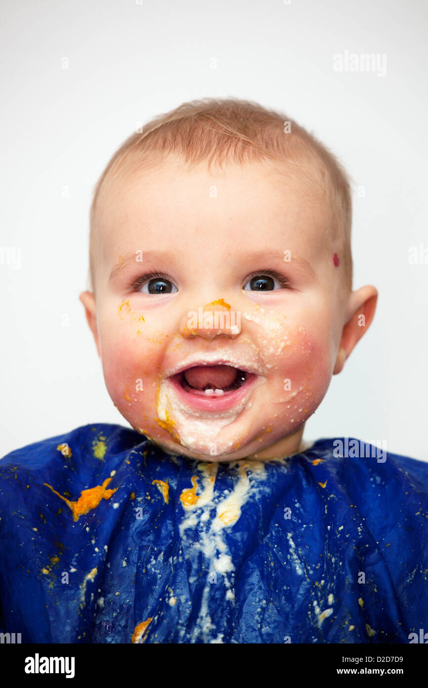 Portrait of a happy baby boy covered in food Stock Photo Alamy