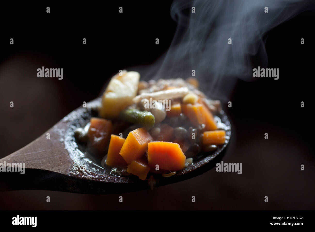 Detail of vegetable stew on a wooden spoon Stock Photo