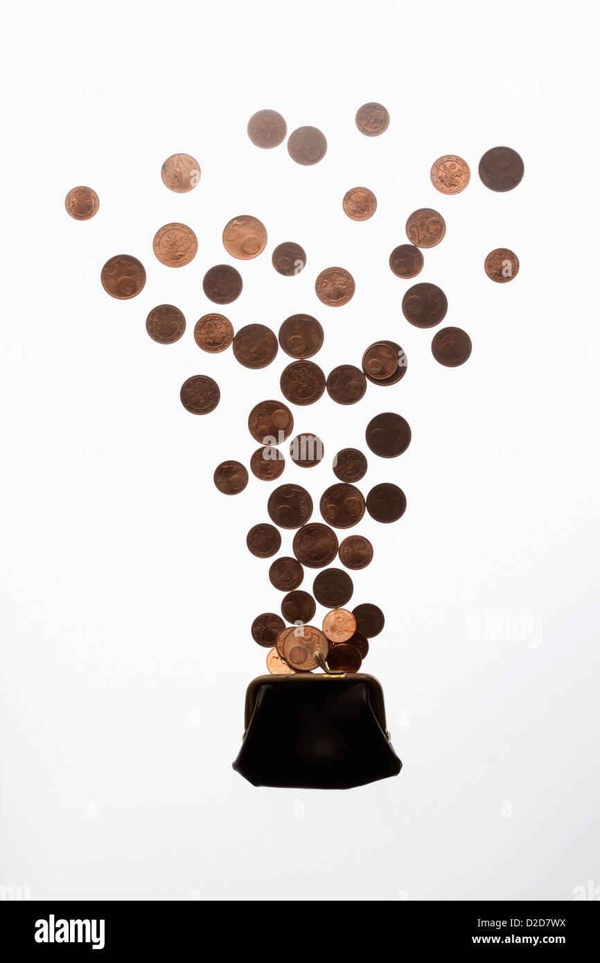 Coins falling into purse Stock Photo - Alamy
