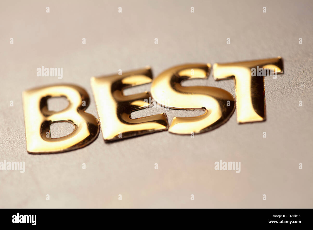 Single word 'best' in gold lettering Stock Photo