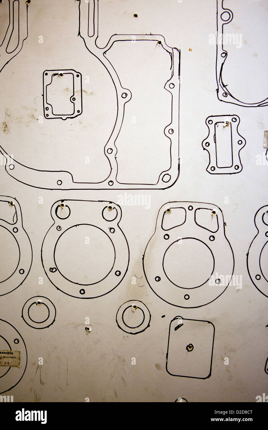 Motorcycle machine part outlines on wall Stock Photo