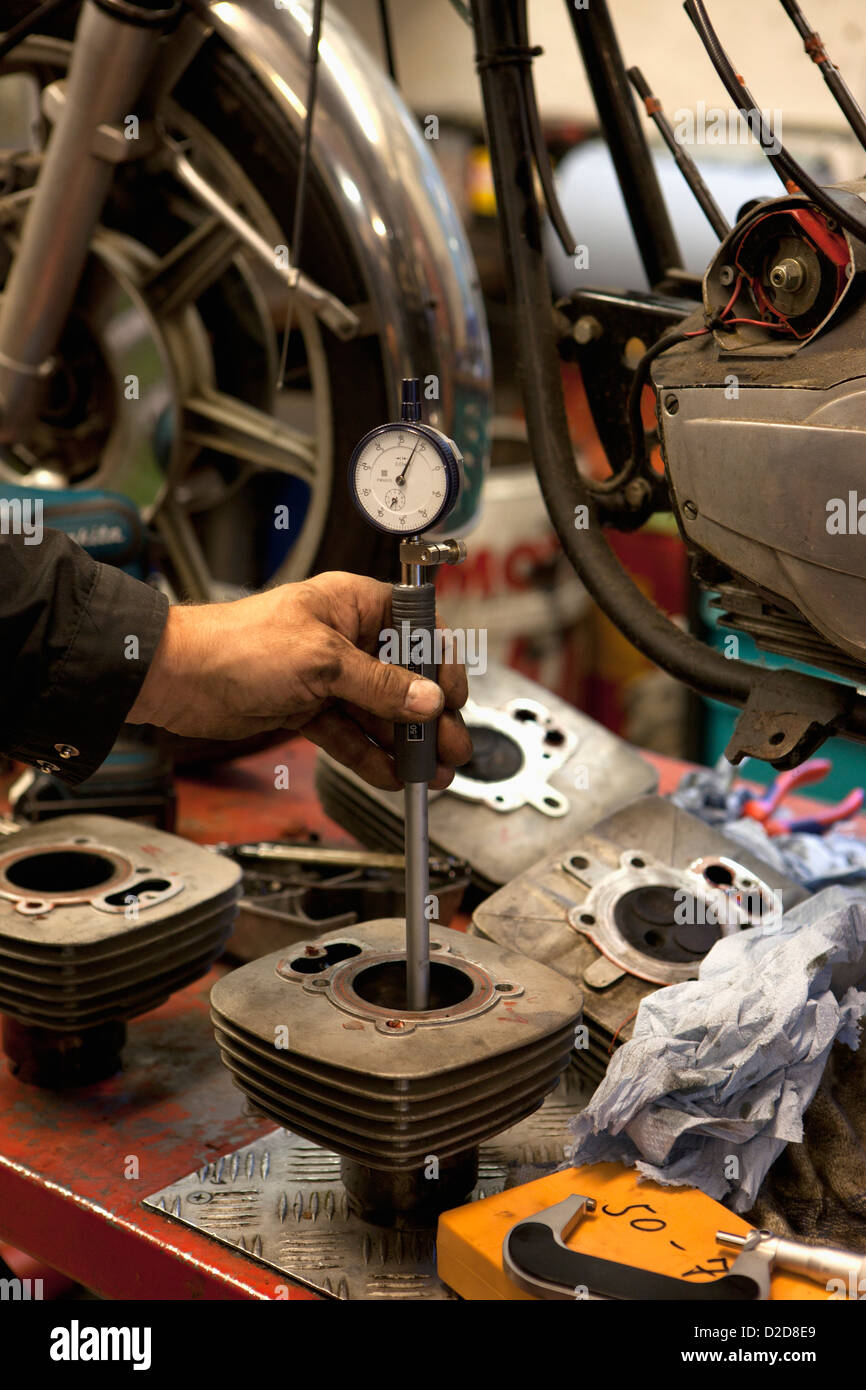 Mechanic checking cylinder bores with a dial bore gauge Stock Photo Alamy