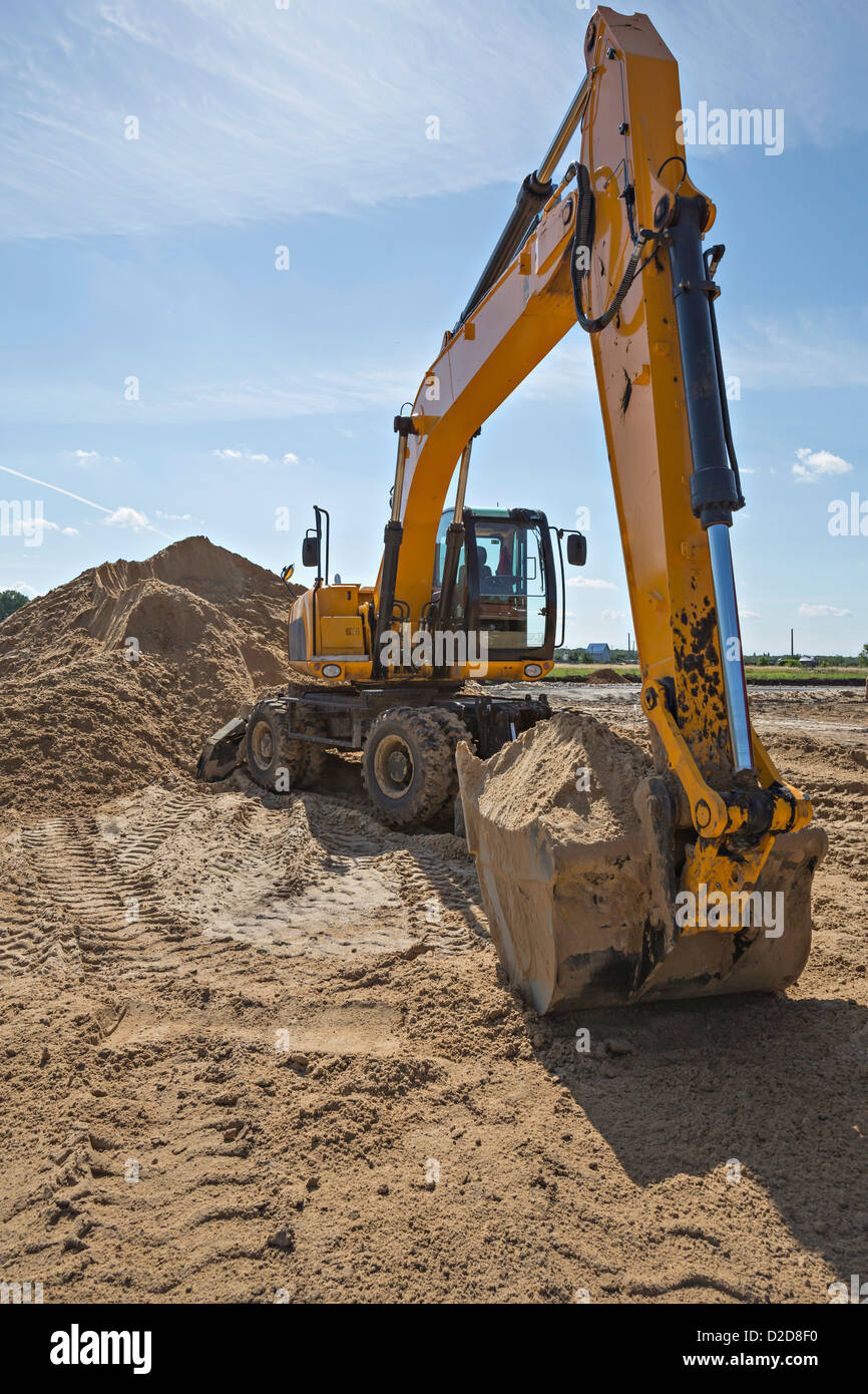Digger scoop full of sand Stock Photo - Alamy