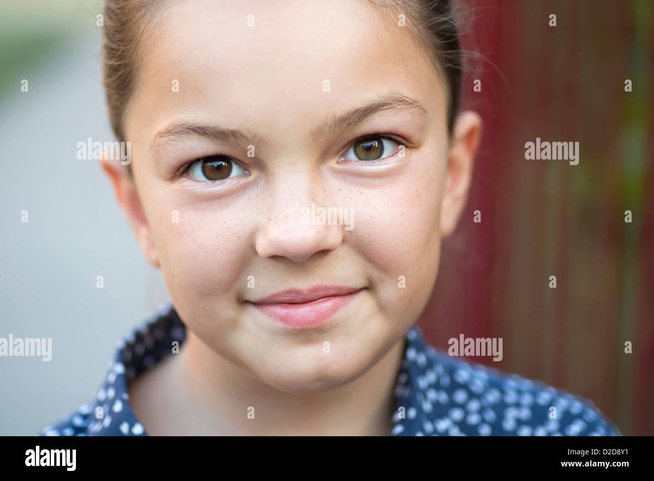 A girl smiling and looking into the camera Stock Photo - Alamy