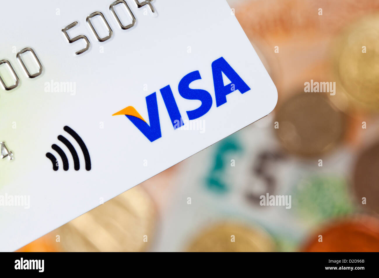 Bath, United Kingdom - November 8, 2011: Close-up of a contactless Visa credit card with UK currency in the background Stock Photo