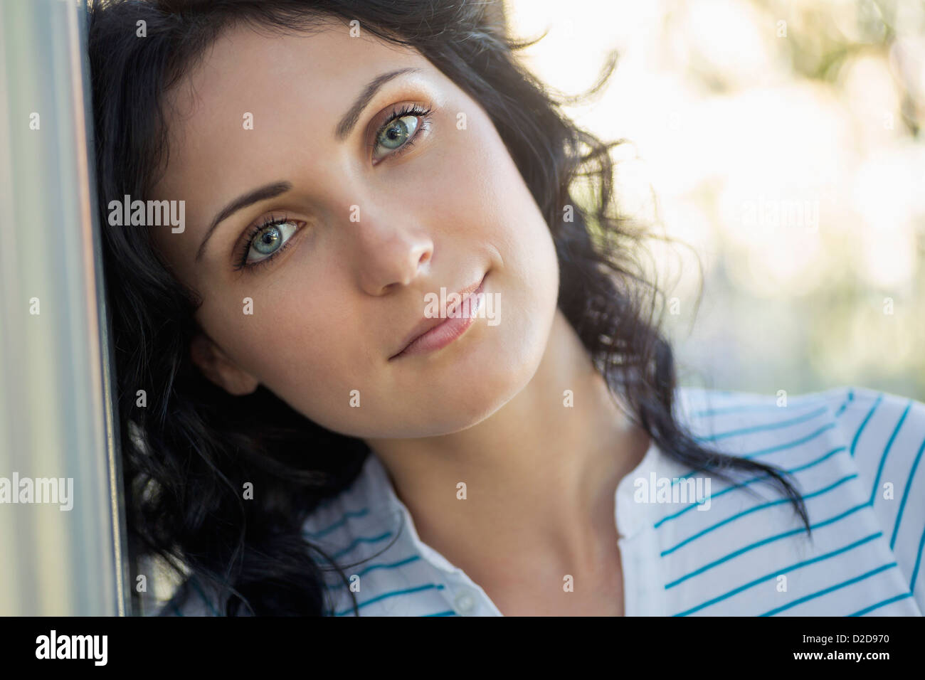 A Beautiful Young Woman Leaning Against A Wall Stock Photo - Alamy