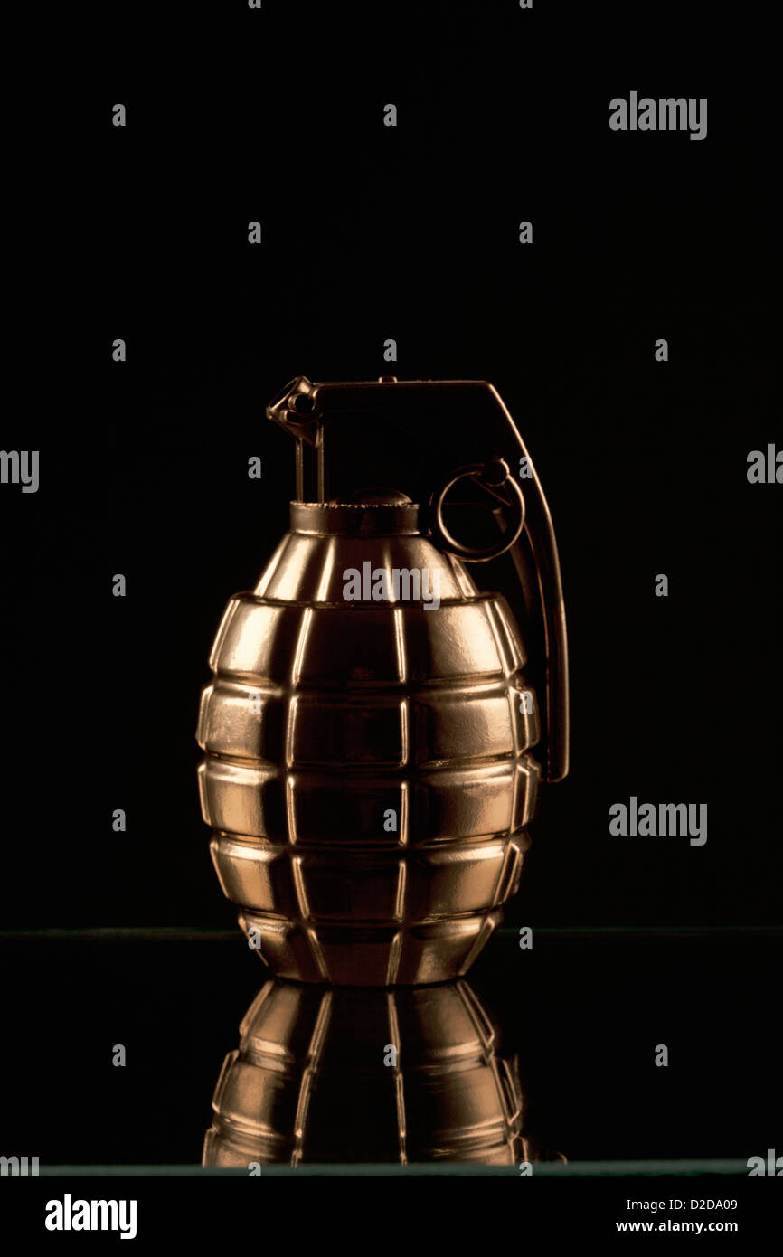 A grenade on a shiny surface, black background Stock Photo