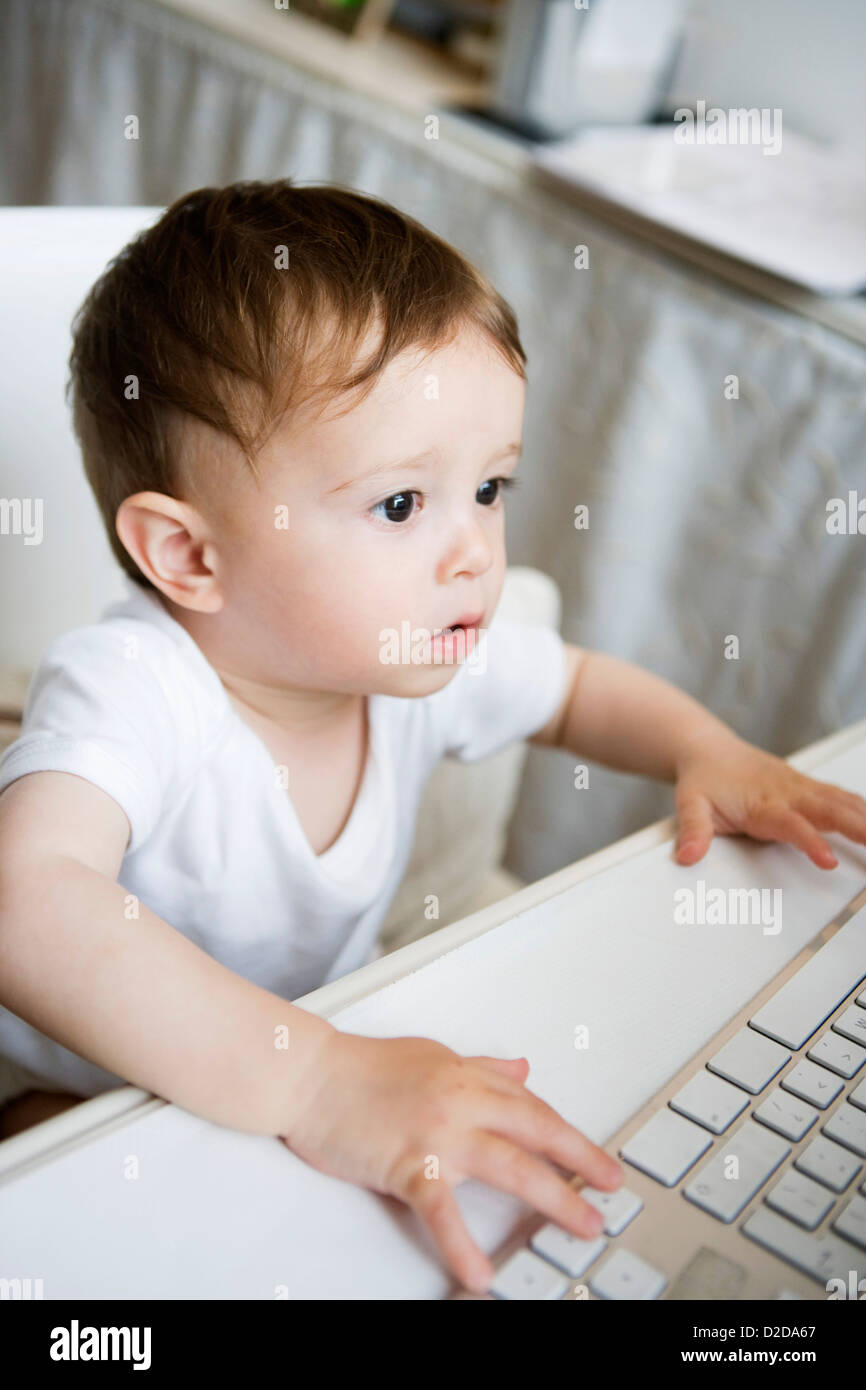 A toddler using a computer keyboard Stock Photo Alamy