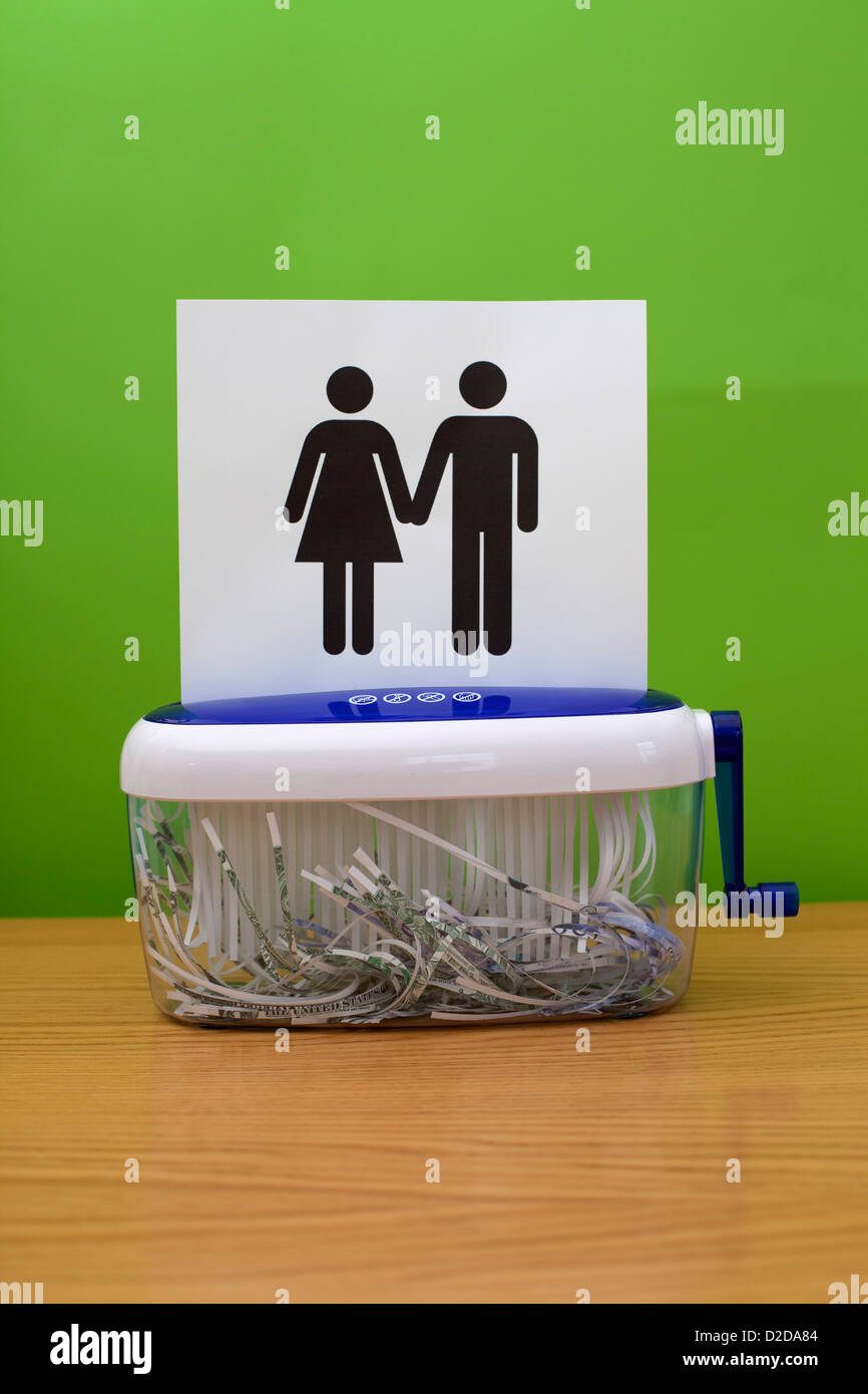 Gender symbols holding hands, about to be shredded Stock Photo