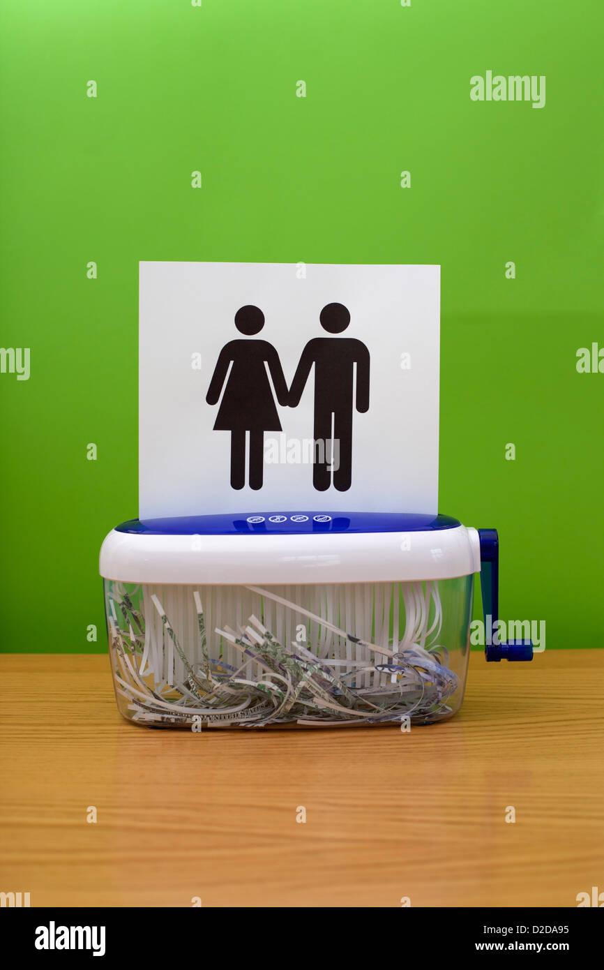 Gender symbols holding hands, about to be shredded Stock Photo
