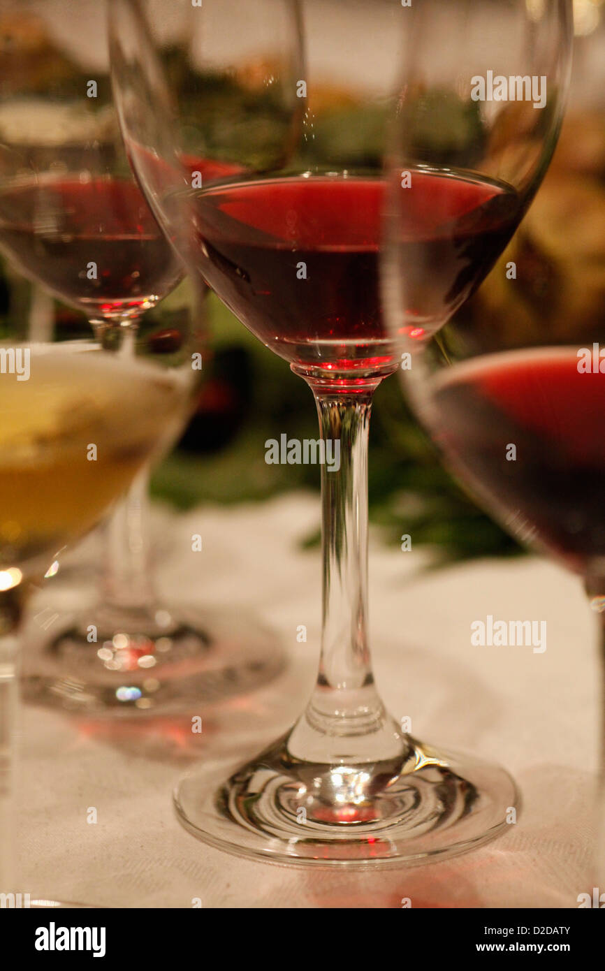 Three glasses of red wine and a glass of white wine at a wine tasting, close-up Stock Photo