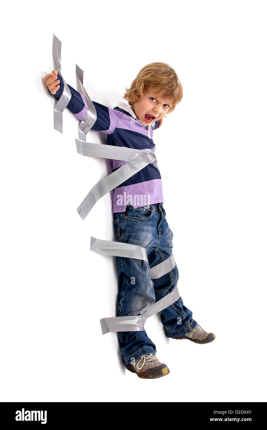 Young angry boy glued to the wall with duct tape Stock Photo Alamy