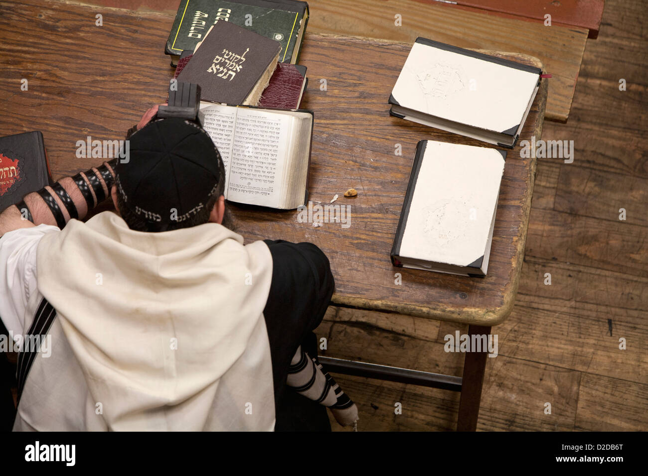 Jewish man with tefillin reading religious prayer book Stock Photo