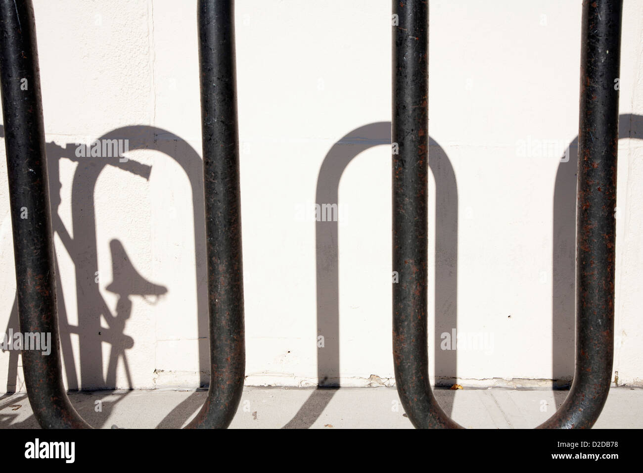 Shadow of bike parked in bicycle stand Stock Photo