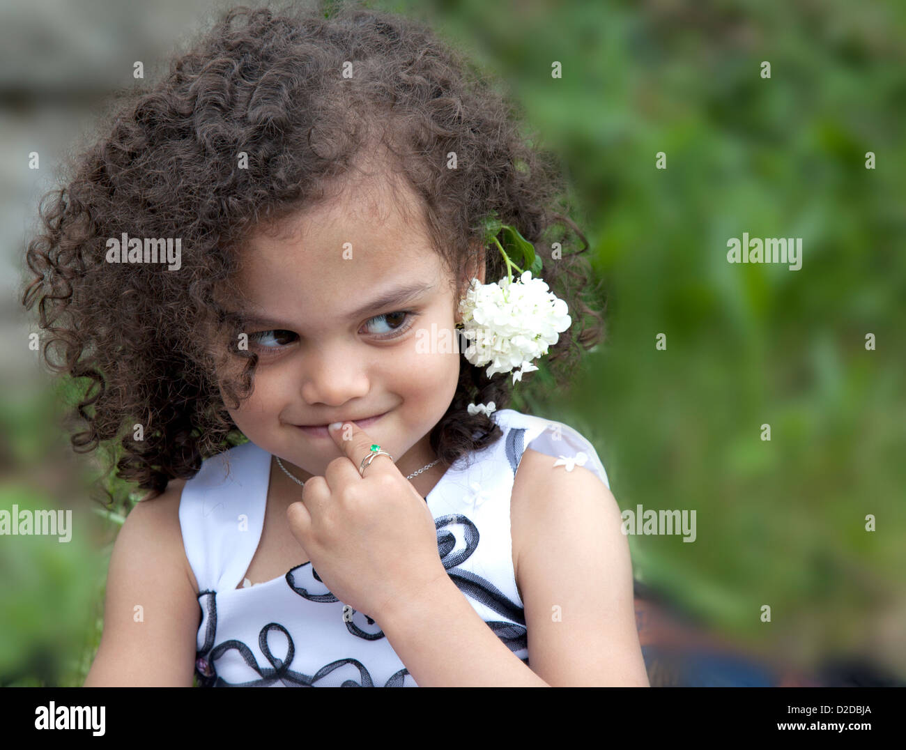 a young multi ethnic child is shy and timid expression Stock Photo