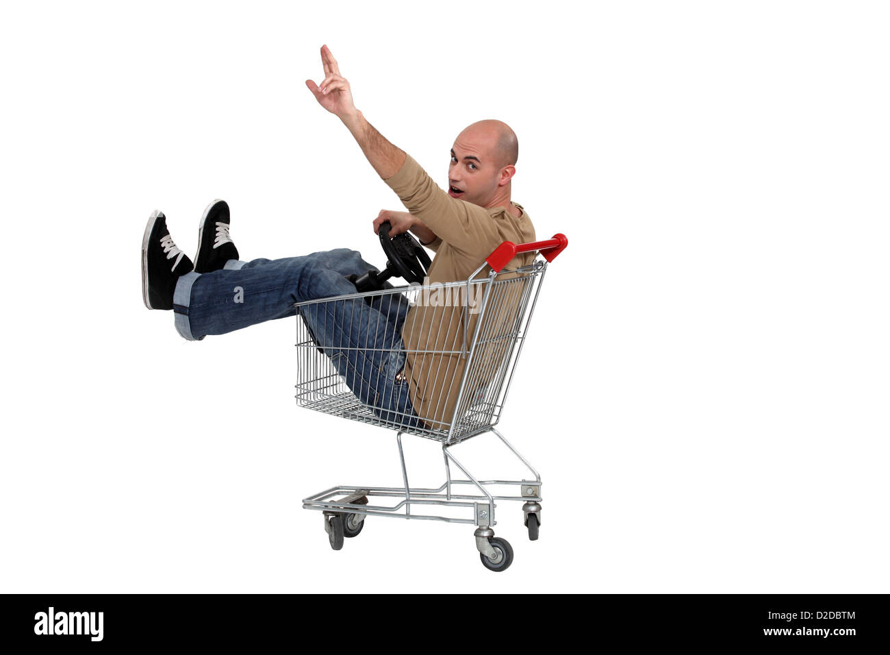 Man in a shopping trolley Stock Photo