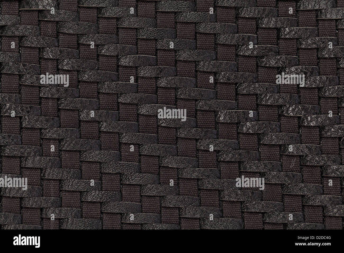 Close-up photo of weaving of black leather and fabric Stock Photo