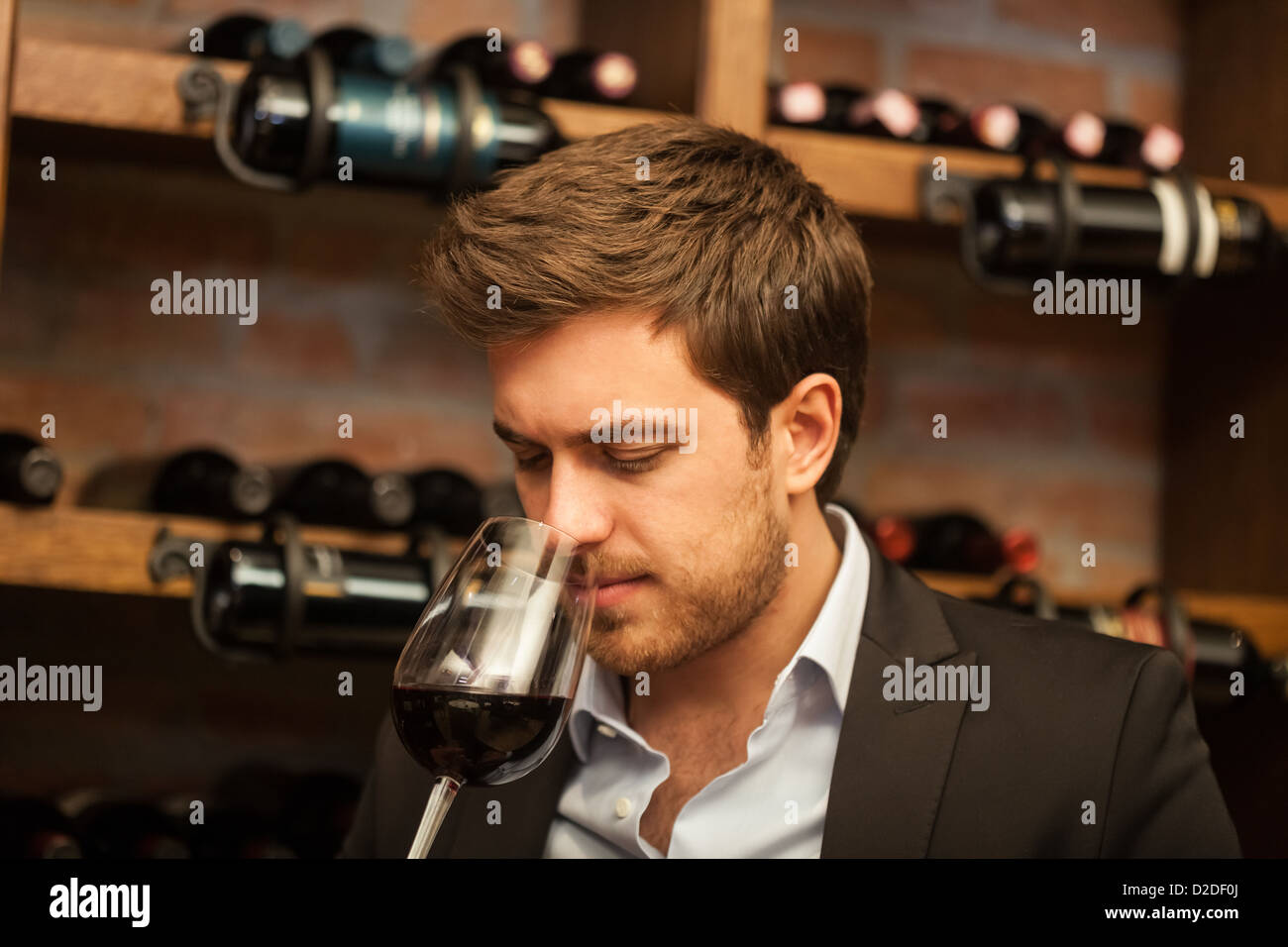 Man tasting a glass of red wine Stock Photo - Alamy