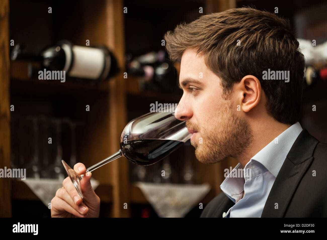Man tasting a glass of red wine Stock Photo - Alamy