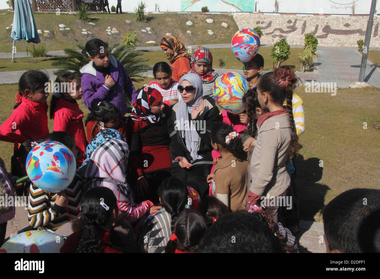 Jan. 21, 2013 - Gaza City, Gaza Strip, Palestinian Territory - Egyptian actor Hanan Turk sings to Palestinian children in a park, in Gaza city on January 21, 2013. Turk and Tarek Dusouqi visit Gaza strip with a delegation representing Islamic Relief Worldwide. Turk said she has been trying to visit Gaza for three years to meet with needy people and deliver their message to the people of the US to help her fundraise for their cause  (Credit Image: © Ezz Al-Zanoon/APA Images/ZUMAPRESS.com) Stock Photo