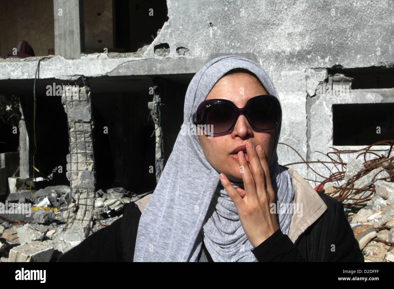 Jan. 21, 2013 - Gaza City, Gaza Strip, Palestinian Territory - Egyptian actor Hanan Turk reacts near the rubble of a house which destroyed in a past Israeli air strike, in Gaza city on January 21, 2013. Turk and Tarek Dusouqi visit Gaza strip with a delegation representing Islamic Relief Worldwide. Turk said she has been trying to visit Gaza for three years to meet with needy people and deliver their message to the people of the US to help her fundraise for their cause  (Credit Image: © Ezz Al-Zanoon/APA Images/ZUMAPRESS.com) Stock Photo