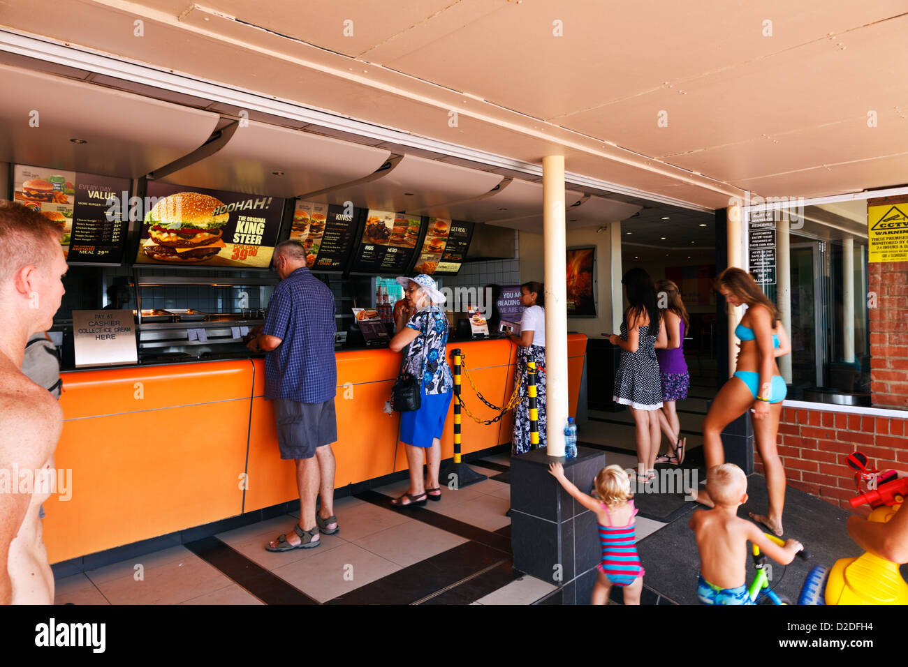Durban, South Africa. Holiday makers and locals queue for takeaways at a local eatery along Durban's beachfront. Durban South Africa. Stock Photo