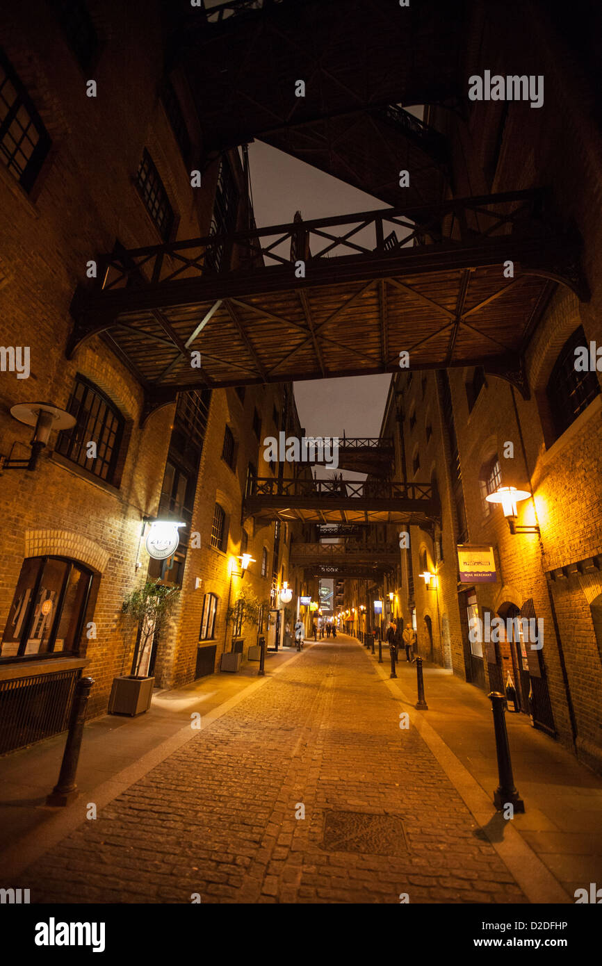 A night view of the converted warehouses and walkways in Shad Thames, London Stock Photo