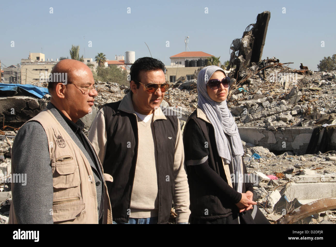 Jan. 21, 2013 - Gaza City, Gaza Strip, Palestinian Territory - Egyptian actors Hanan Turk and Tarek Dusouqi stand on  the rubble of a house which destroyed in a past Israeli air strike, in Gaza city on January 21, 2013. Turk and Dusouqi visit Gaza strip with a delegation representing Islamic Relief Worldwide. Turk said she has been trying to visit Gaza for three years to meet with needy people and deliver their message to the people of the US to help her fundraise for their cause  (Credit Image: © Ezz Al-Zanoon/APA Images/ZUMAPRESS.com) Stock Photo