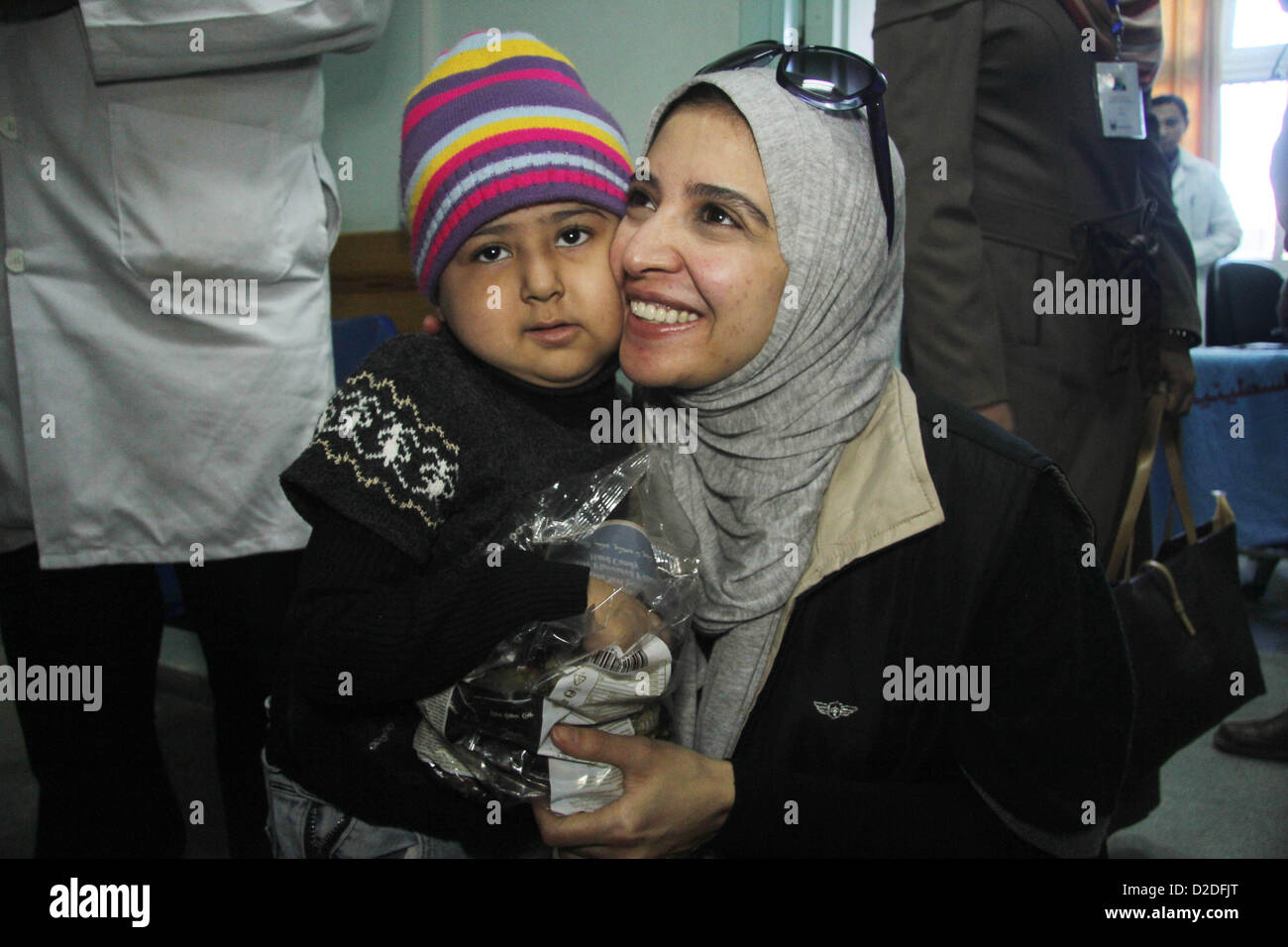 Jan. 21, 2013 - Gaza City, Gaza Strip, Palestinian Territory - Egyptian actor Hanan Turk carries a baby boy at al-Shifa hospital, in Gaza city on January 21, 2013. Turk and Tarek Dusouqi visit Gaza strip with a delegation representing Islamic Relief Worldwide. Turk said she has been trying to visit Gaza for three years to meet with needy people and deliver their message to the people of the US to help her fundraise for their cause  (Credit Image: © Ezz Al-Zanoon/APA Images/ZUMAPRESS.com) Stock Photo
