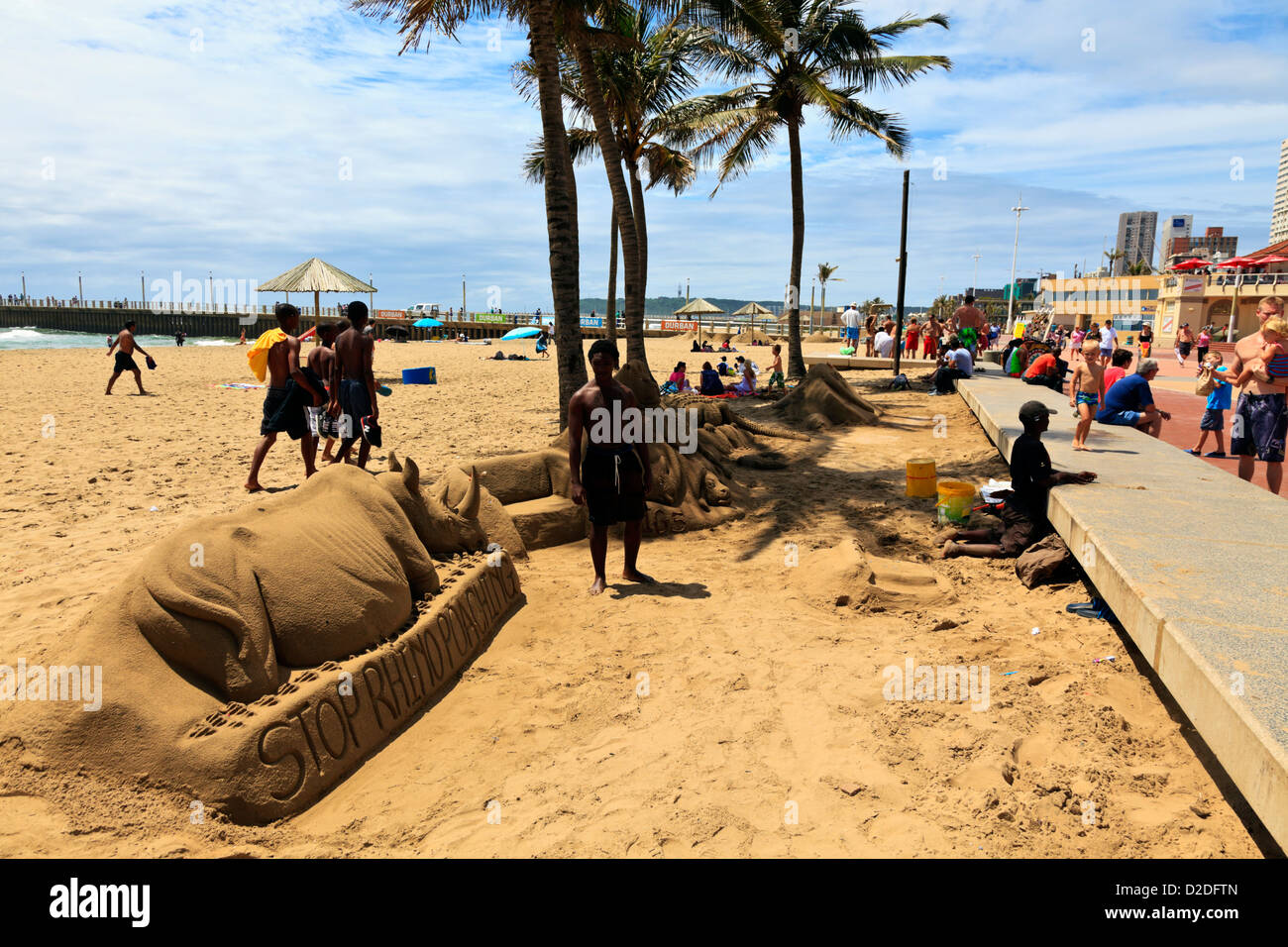 Durban, South Africa. Sand sculptors hope for passing holiday makers to